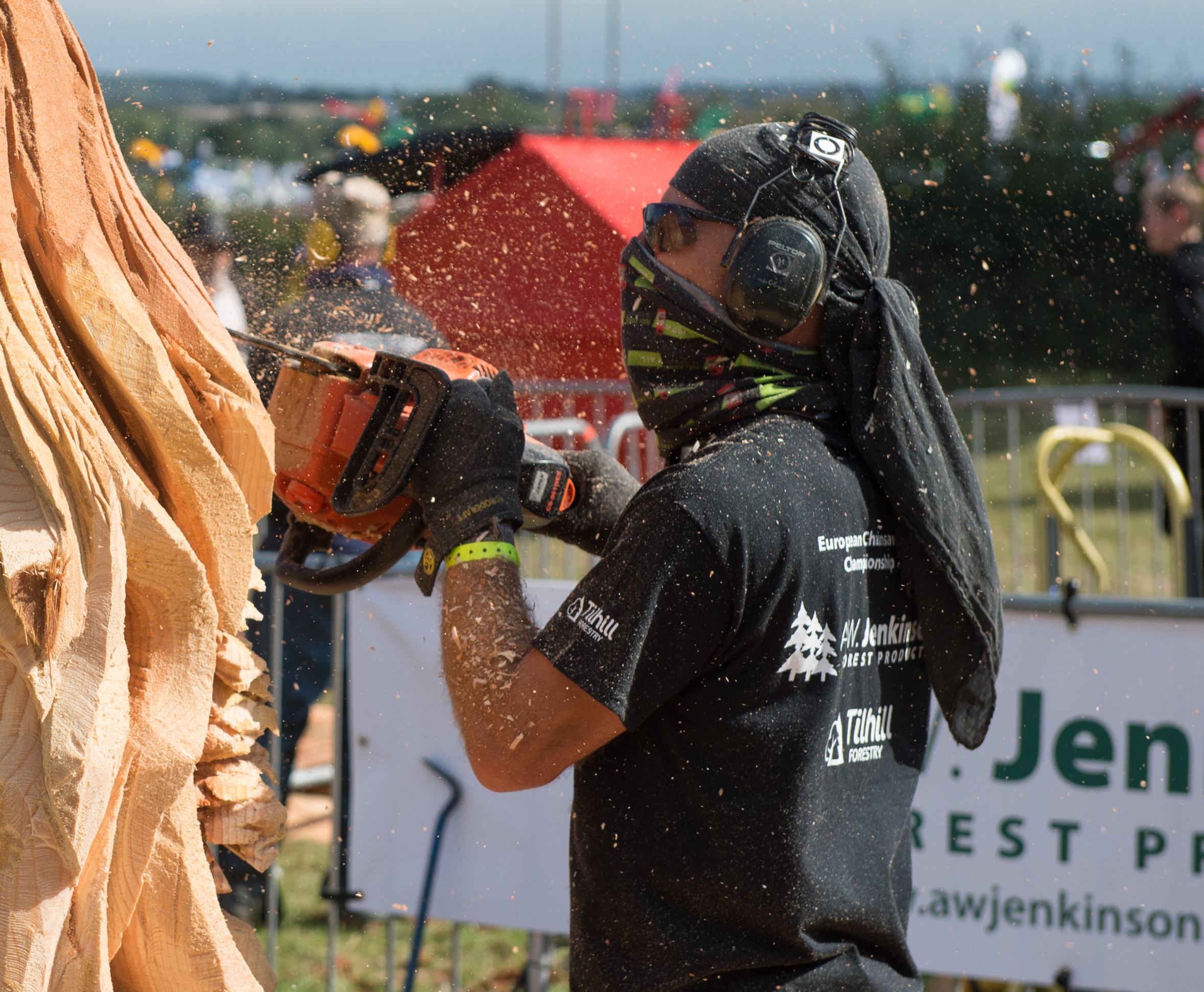 Individual doing chainsaw carving